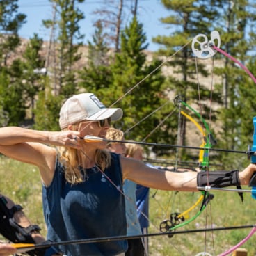 Woman with a bow and arrow | Archery family activity