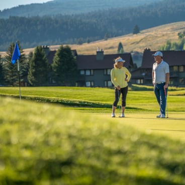 Two golfers on a green at the Big Sky Golf Course