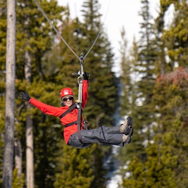Woman in snow clothes on a zipline