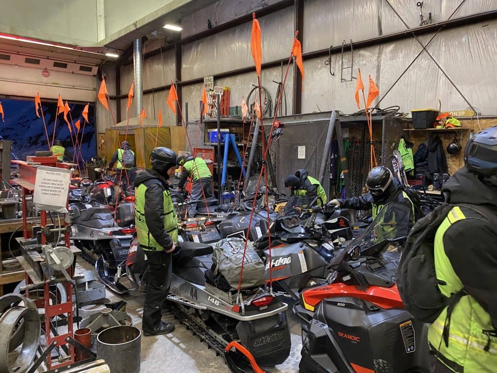 Mountain Operations team with snowmobiles