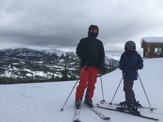 Parent and child in ski gear