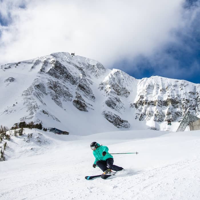 Skier in front of Lone Peak
