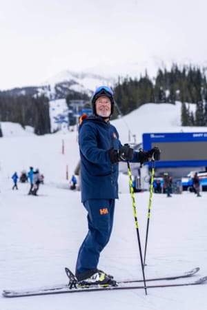 Skier with rental skis in the Big Sky Mountain Village