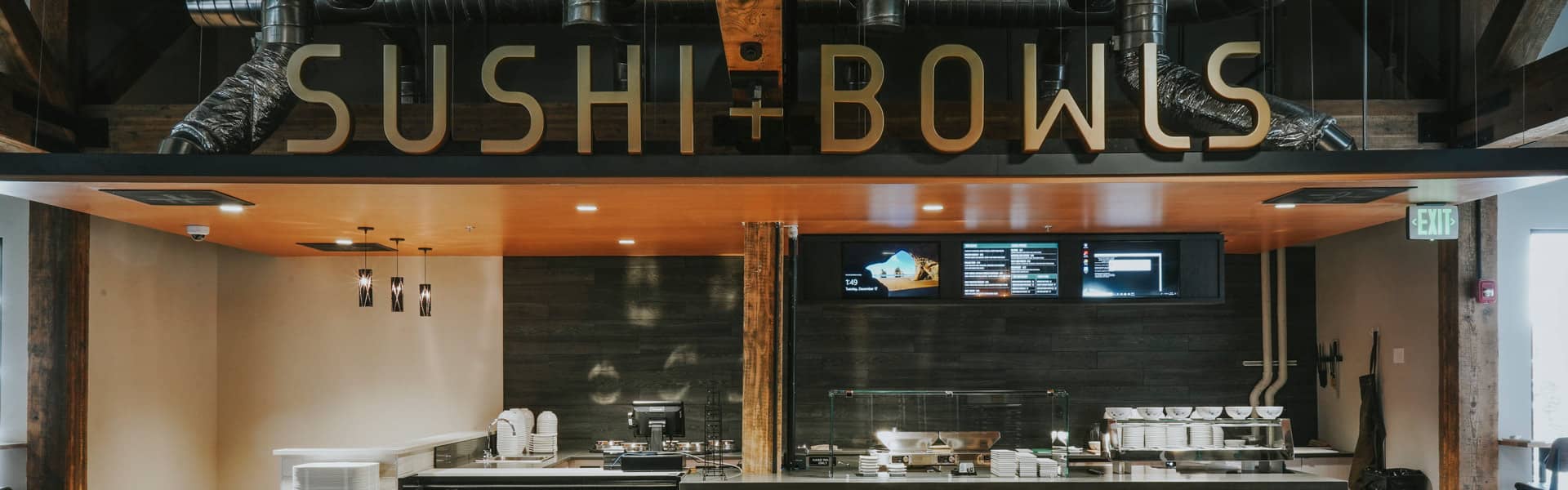 Sushi + Bowls sign over the kitchen