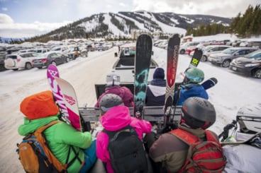 Skiers on a parking shuttle
